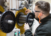 bindatex thermoplastic carbon fibre on spooling machine with operator medium