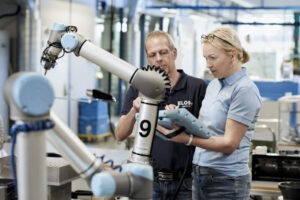 Two people working with a Cobot scaled 1